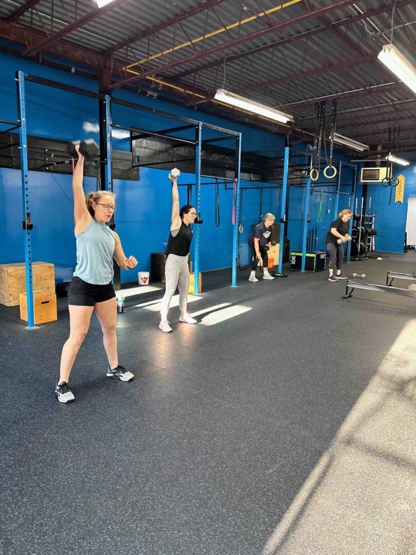 A group of people are doing exercises in a gym.