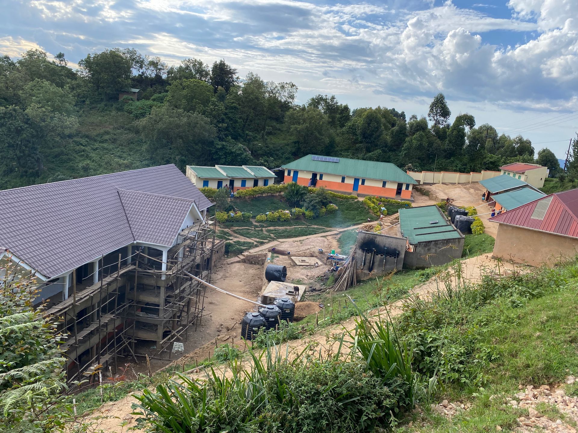 a group of buildings are being built on top of a hill .