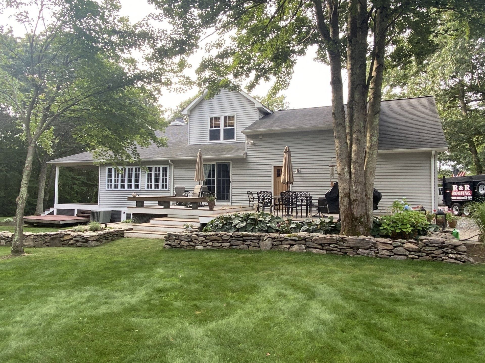 A large white house with a large lawn in front of it.