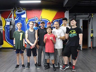 Exercise — Boxing Coach with Trainees in the Gym in Scottsdale, AZ