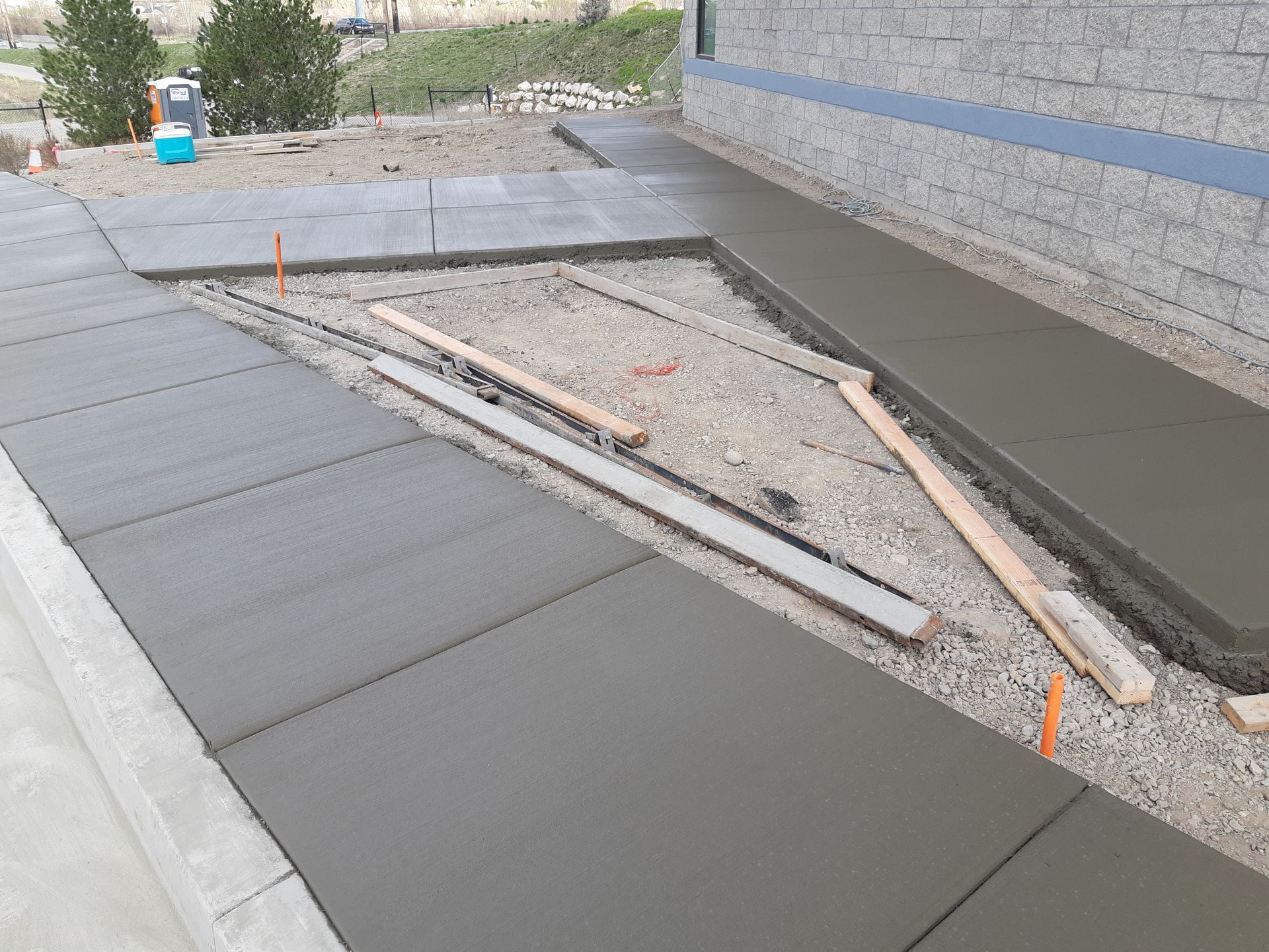 A driveway leading to a large house with a lush green lawn.