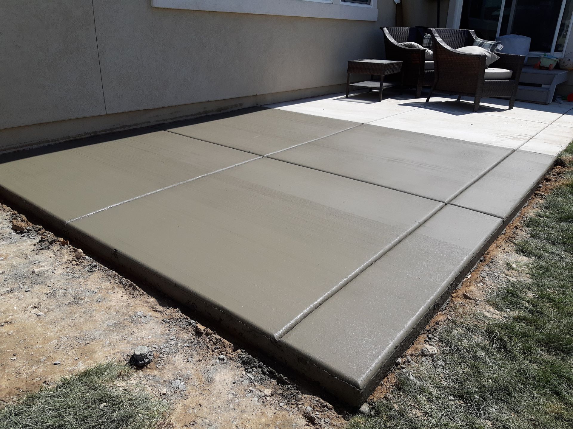 A white house with a table and chairs in front of it