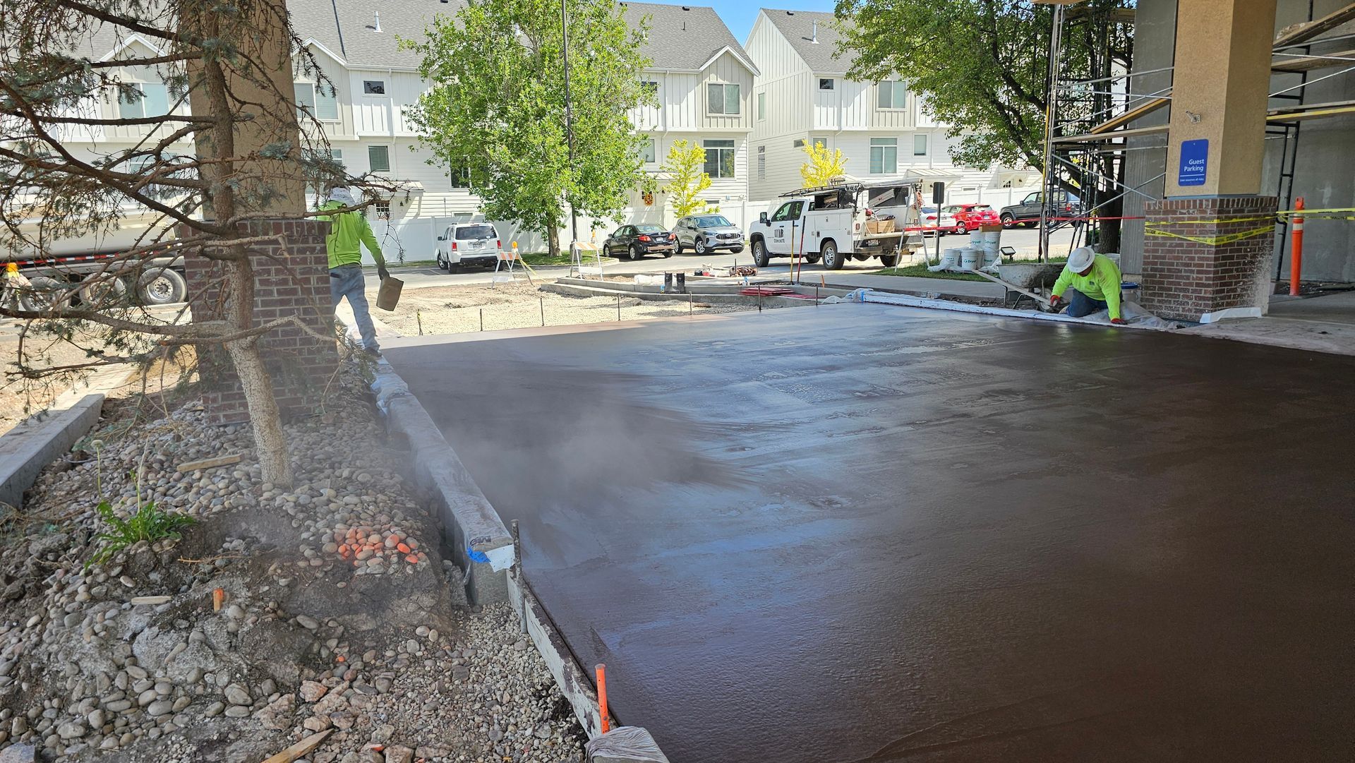 A red car is parked in front of a modern house.