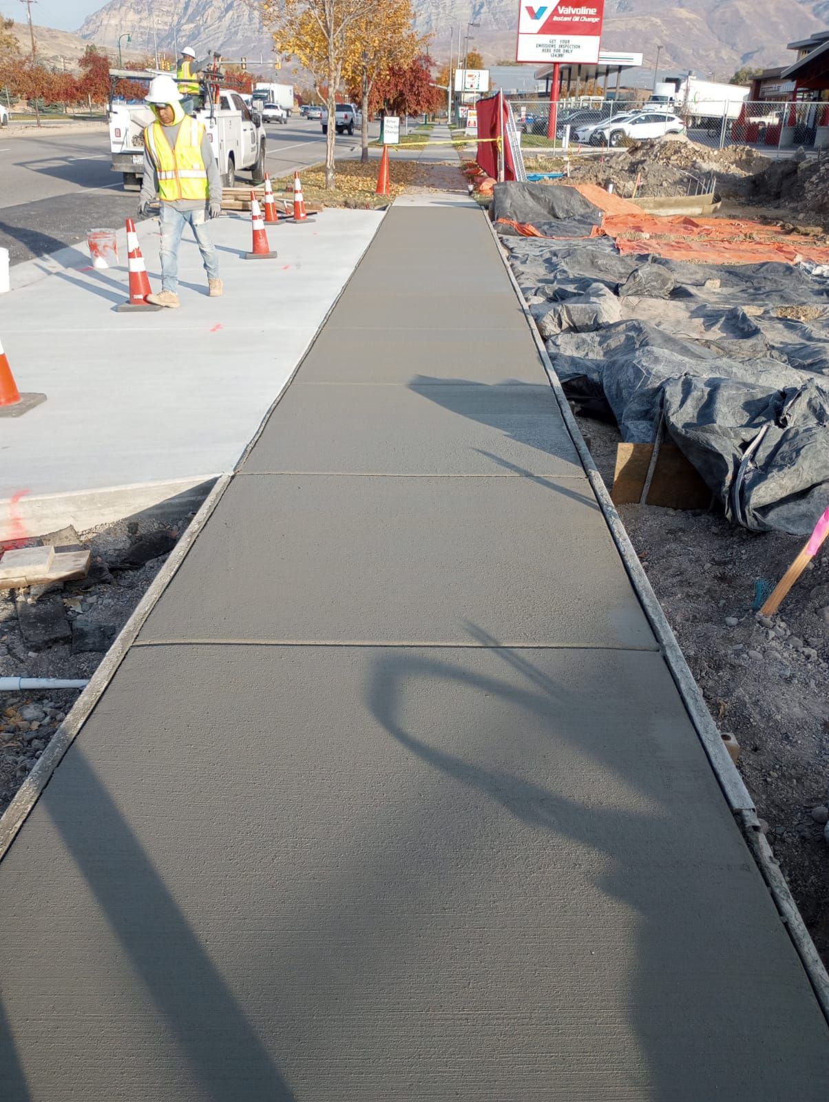 A white house with a lush green lawn and a walkway leading to it.