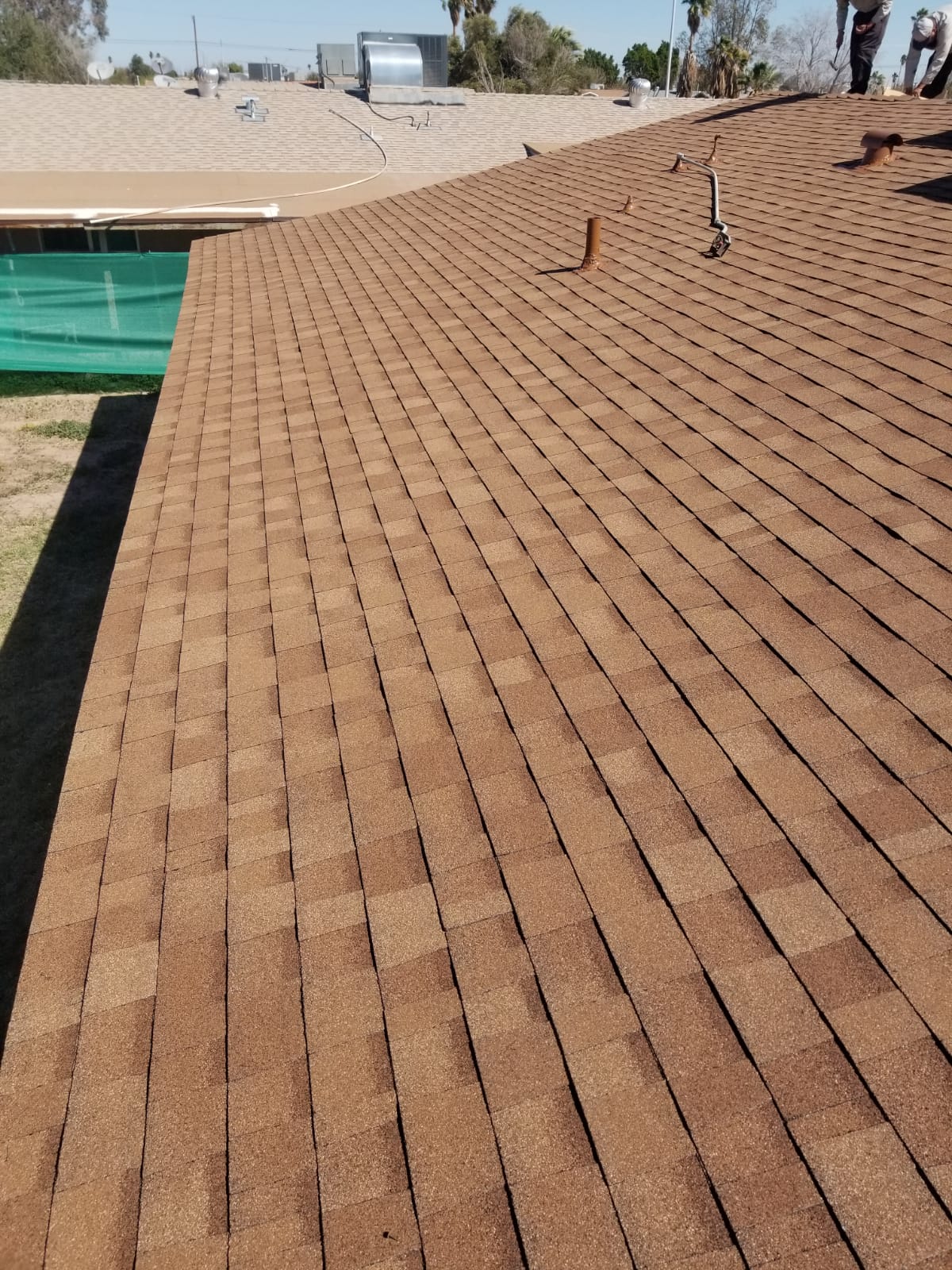Barajas Roofing after installing brown shingles roof