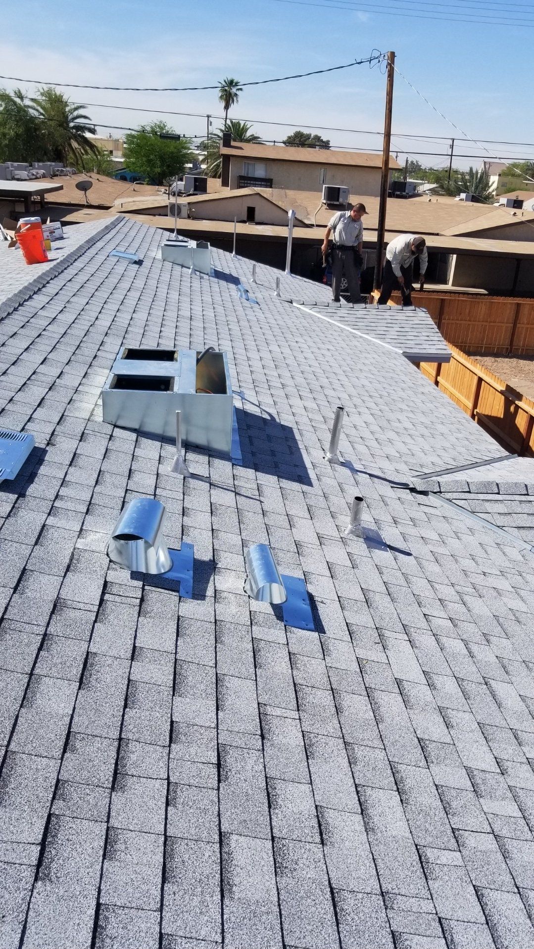 Roofing workers installing a roof