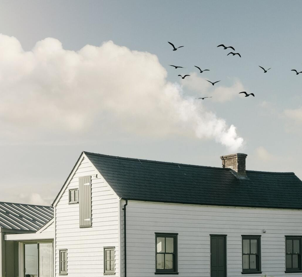 Roofing house with smoke coming out of the chimney