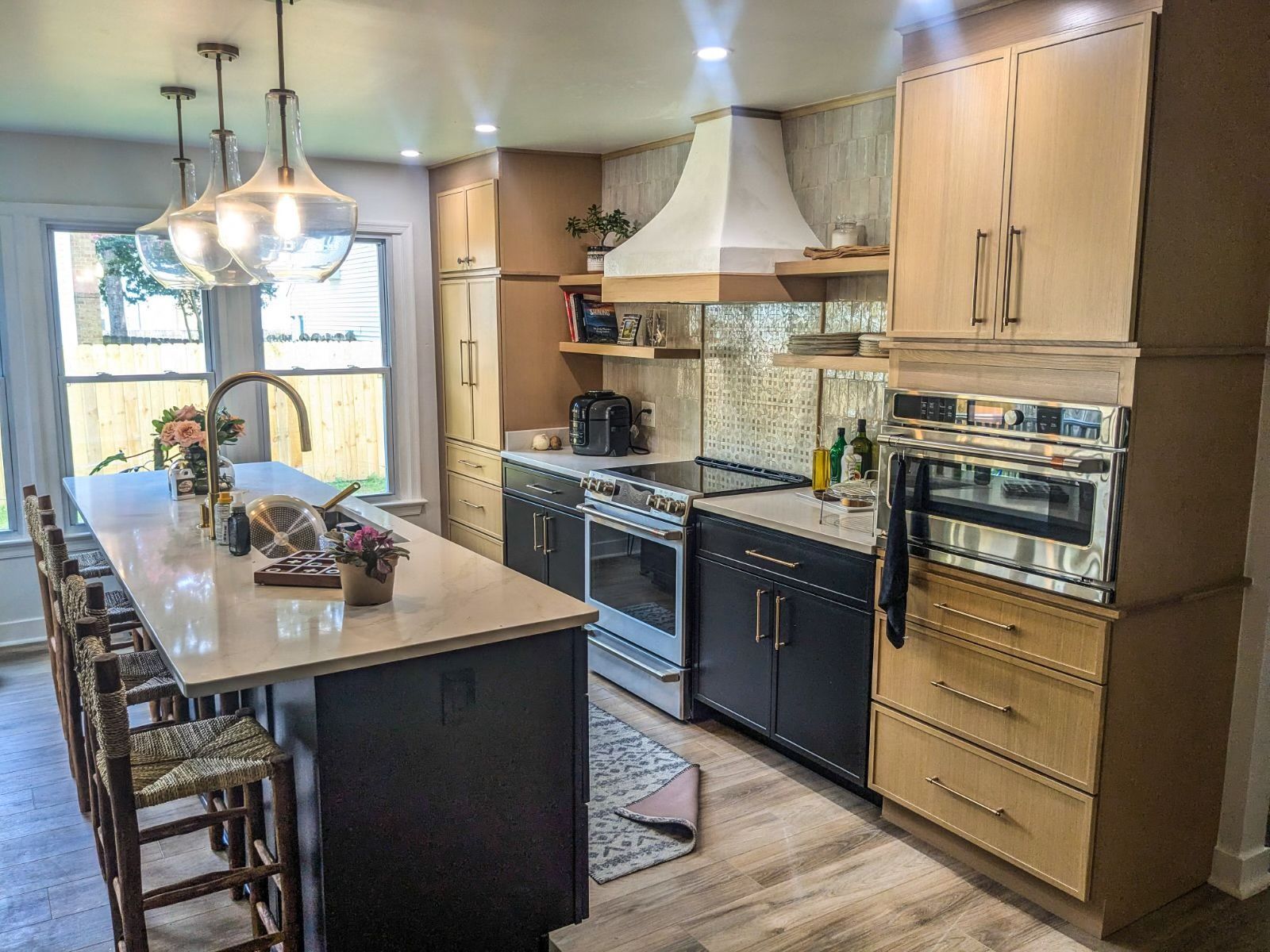 A kitchen with stainless steel appliances , wooden cabinets , and a large island.