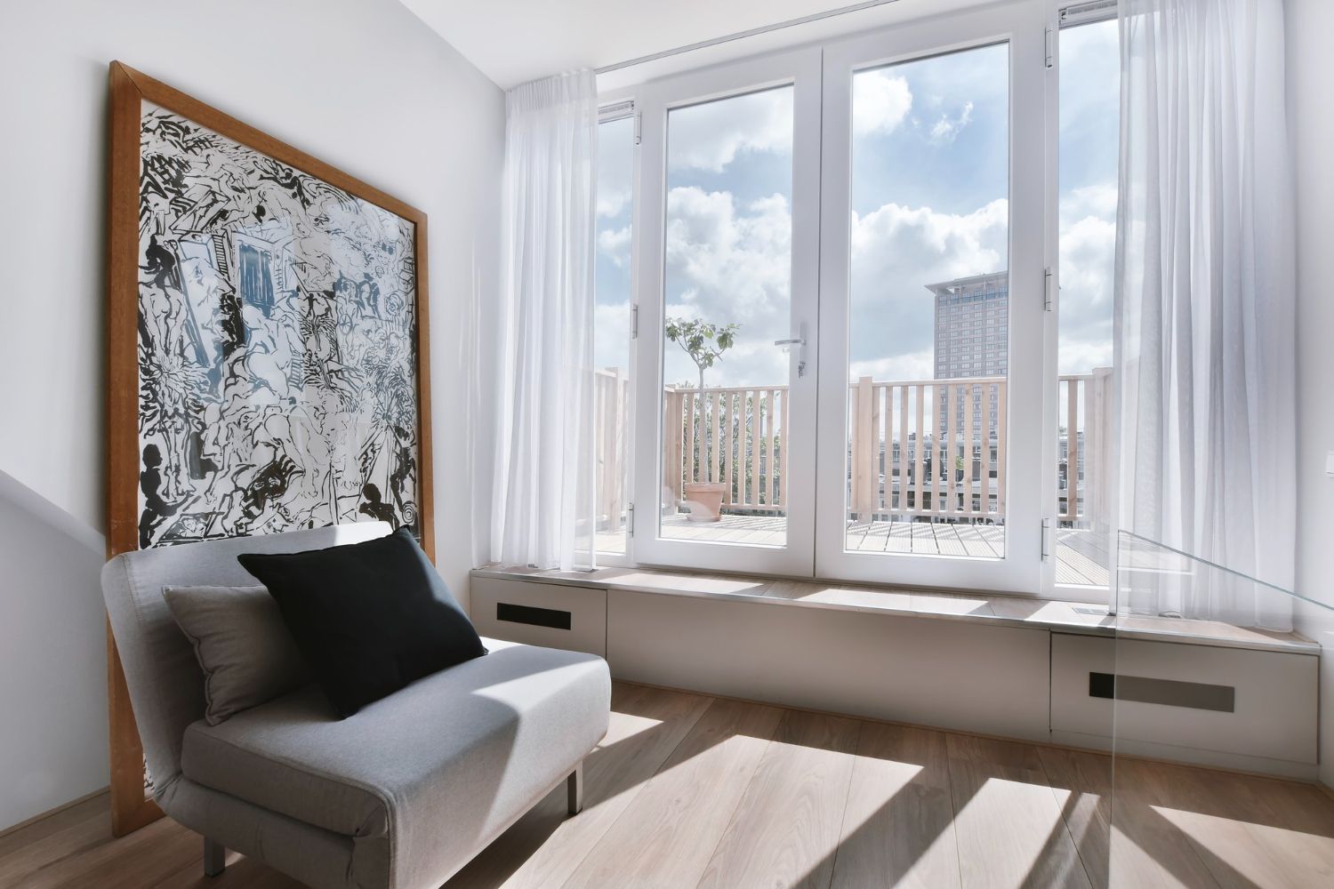 A living room with a chair and a large window