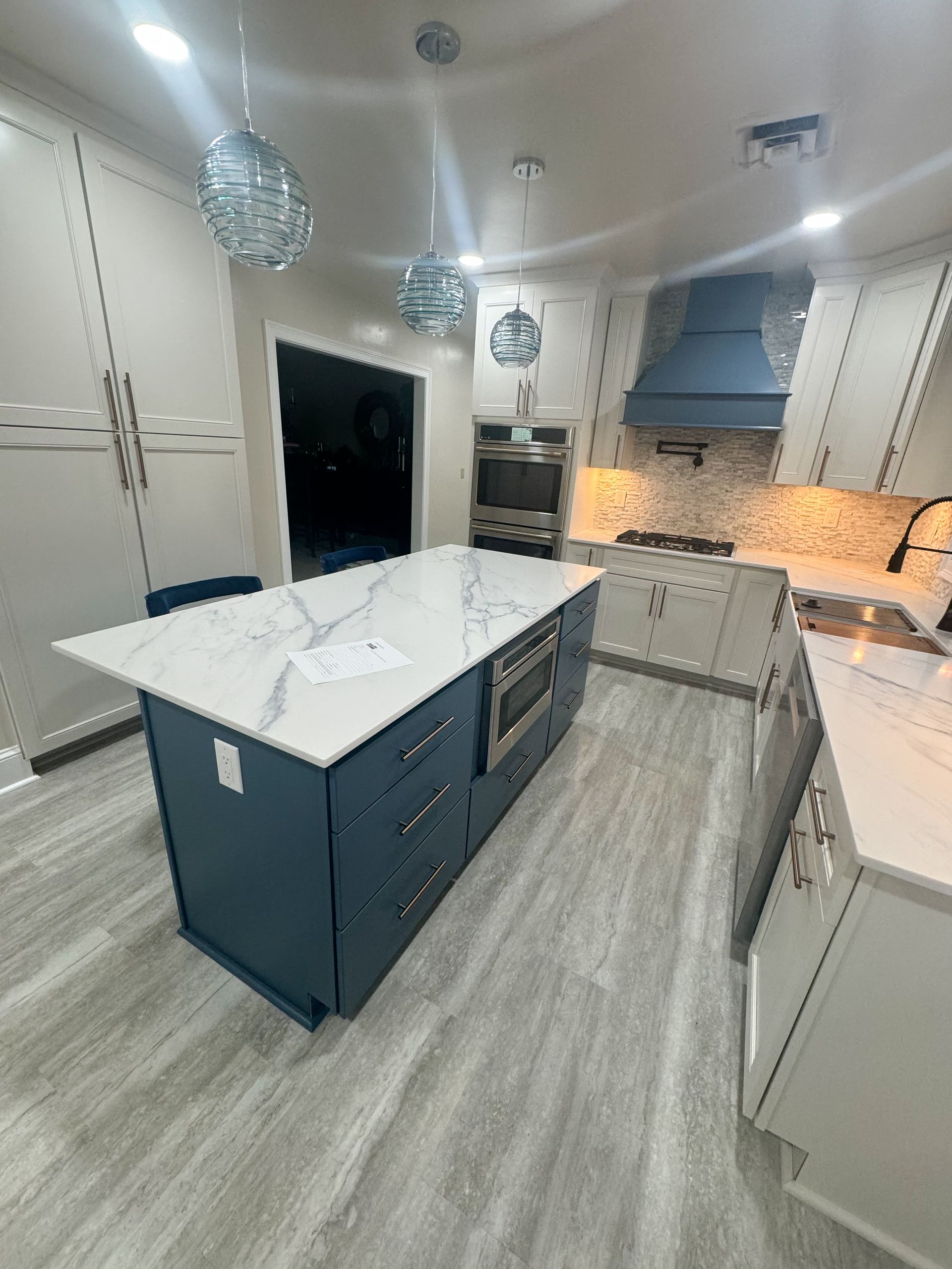 A kitchen with a large island in the middle of it.