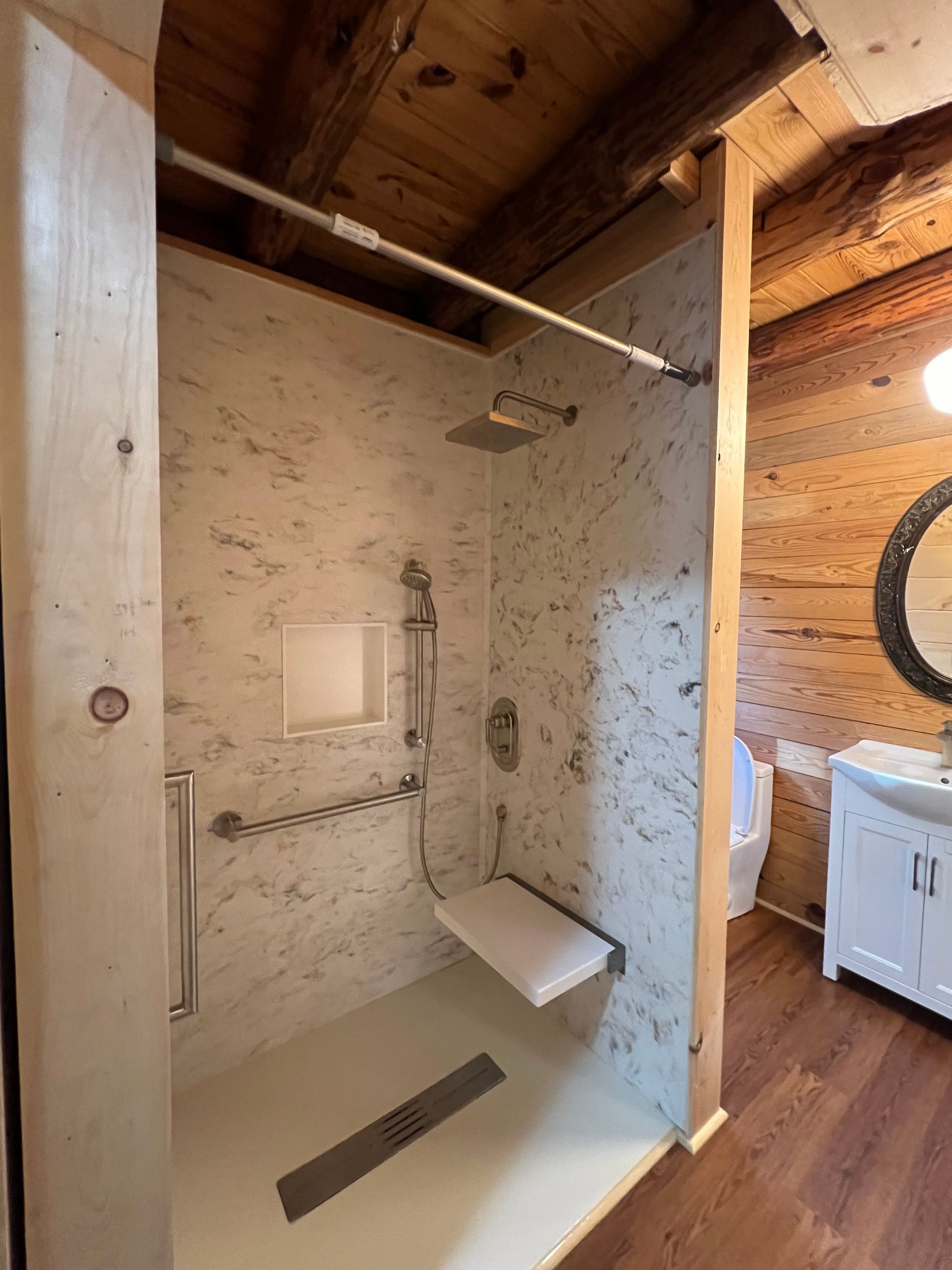 A bathroom with a walk in shower and a toilet.