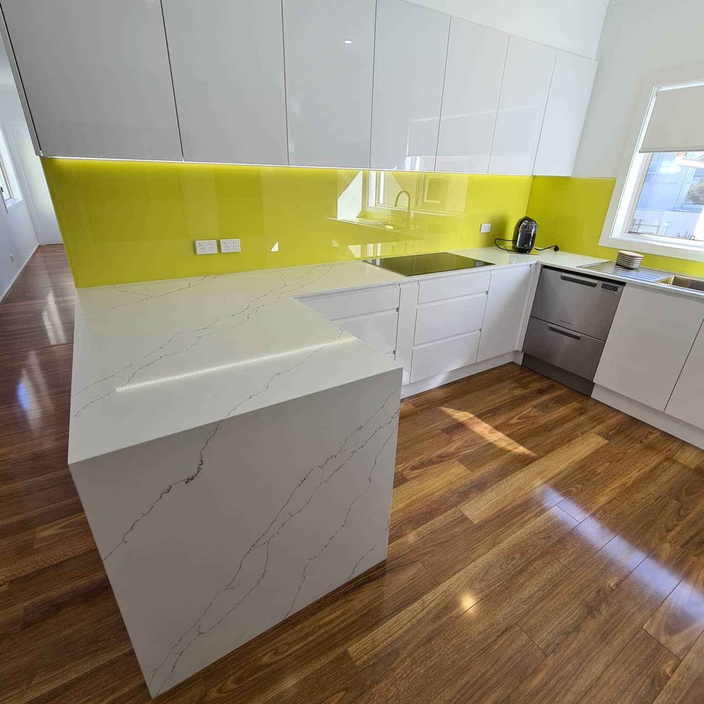 A Modern Kitchen With Hardwood Flooring —  Bathroom Renovation in Medowie, NSW