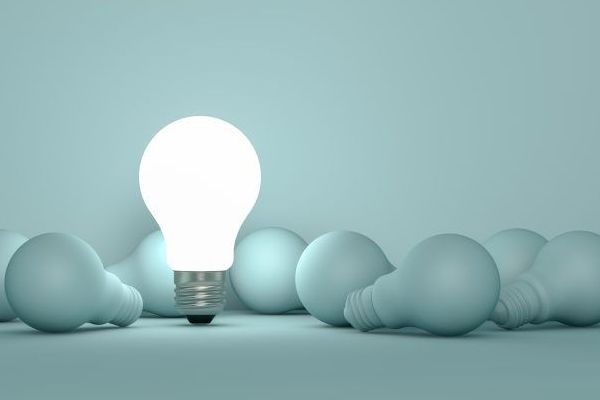 a man in a suit and tie and a woman in a blue shirt are posing for a picture .