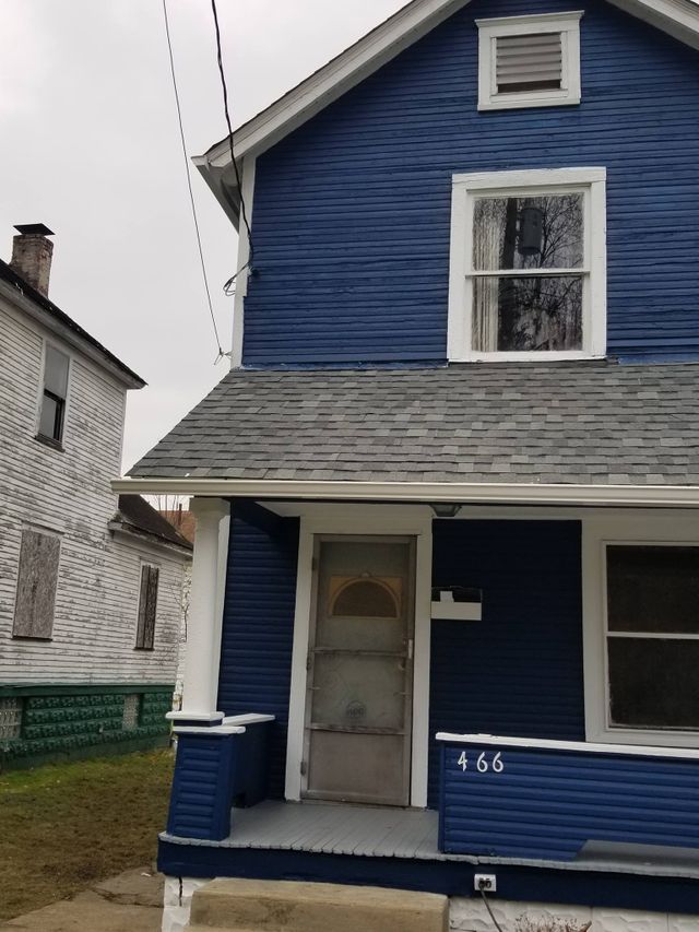 Blue two-story house with white trim, a covered porch, and house number 466