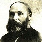 A black and white photo of a man with a beard.