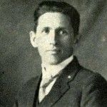 A black and white photo of a man in a suit and tie.