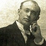 A black and white photo of a man in a suit and bow tie.