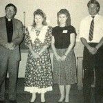 A group of people are standing next to each other in a black and white photo.