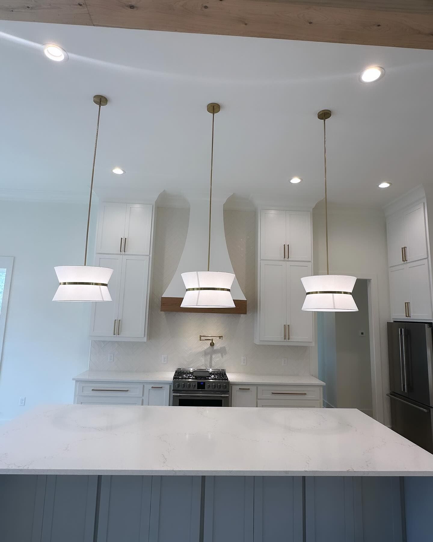A kitchen with white cabinets and a stove top oven