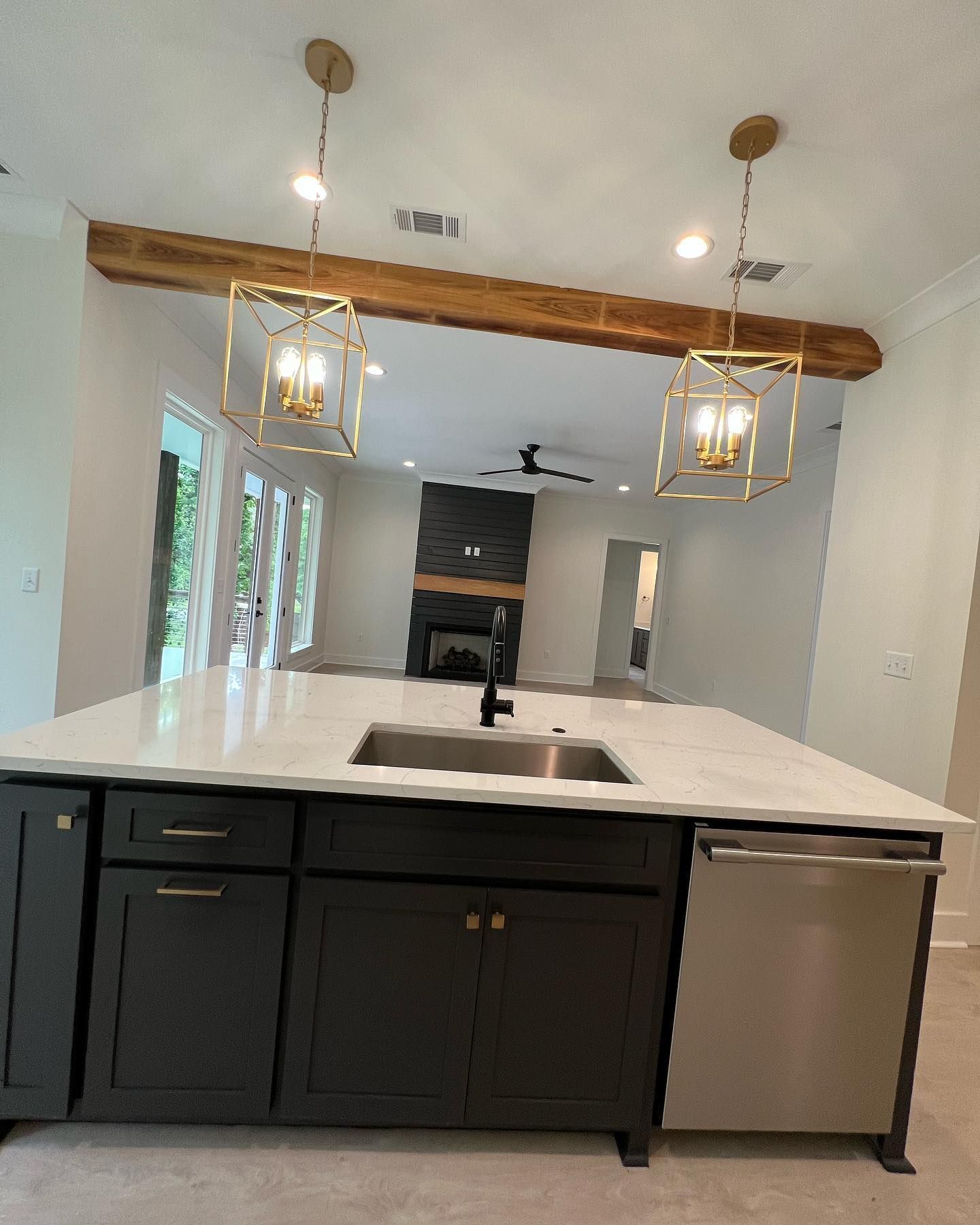 A kitchen with a sink , cabinets , and a dishwasher.