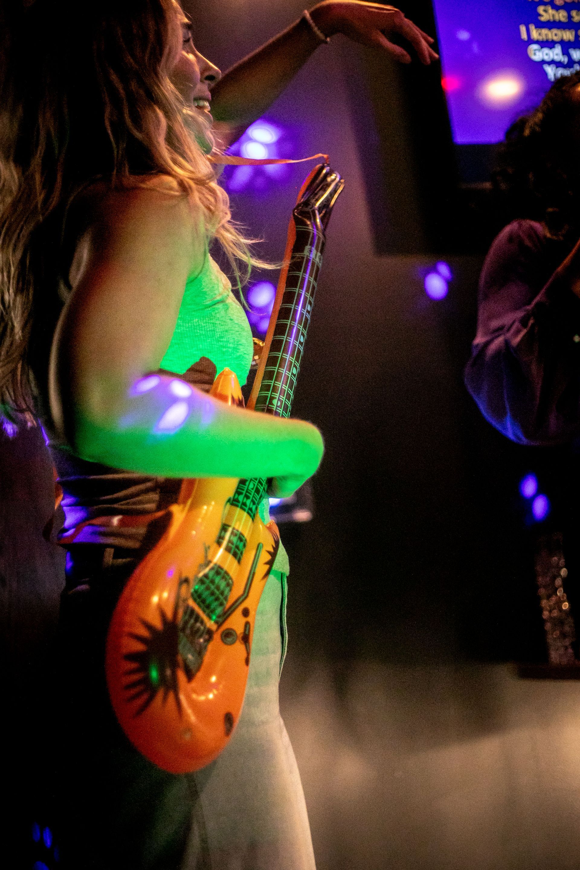 Person using props in the karaoke room to enhance their experience