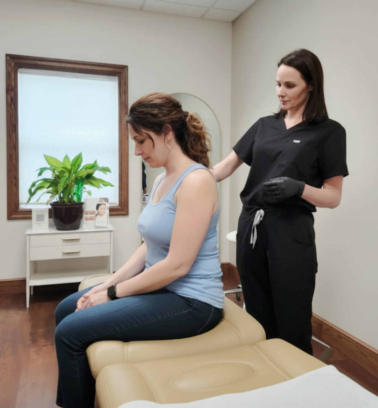 Woman receiving medical examination from another in a clinic.