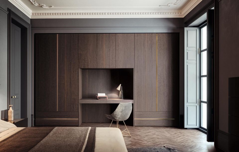 camera da letto con armadi in legno scuro e scrivania