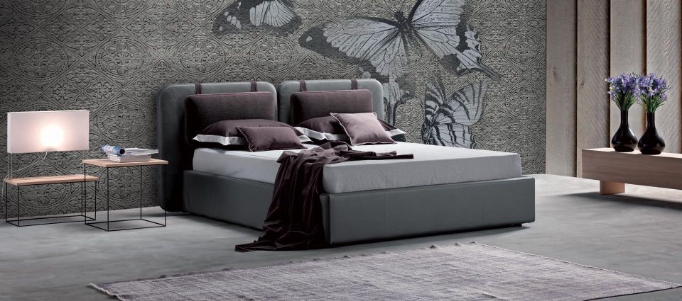 letto matrimoniale grigio con cuscini viola
