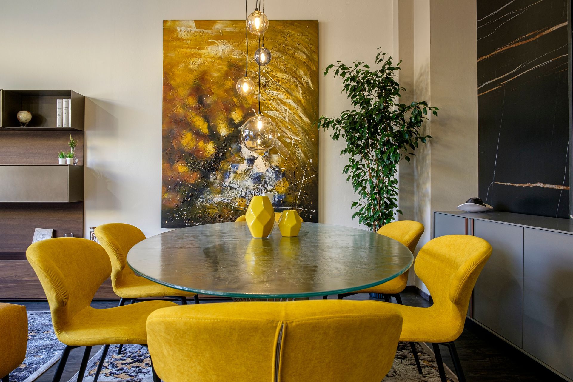 Una sala da pranzo con sedie gialle e un tavolo di vetro.