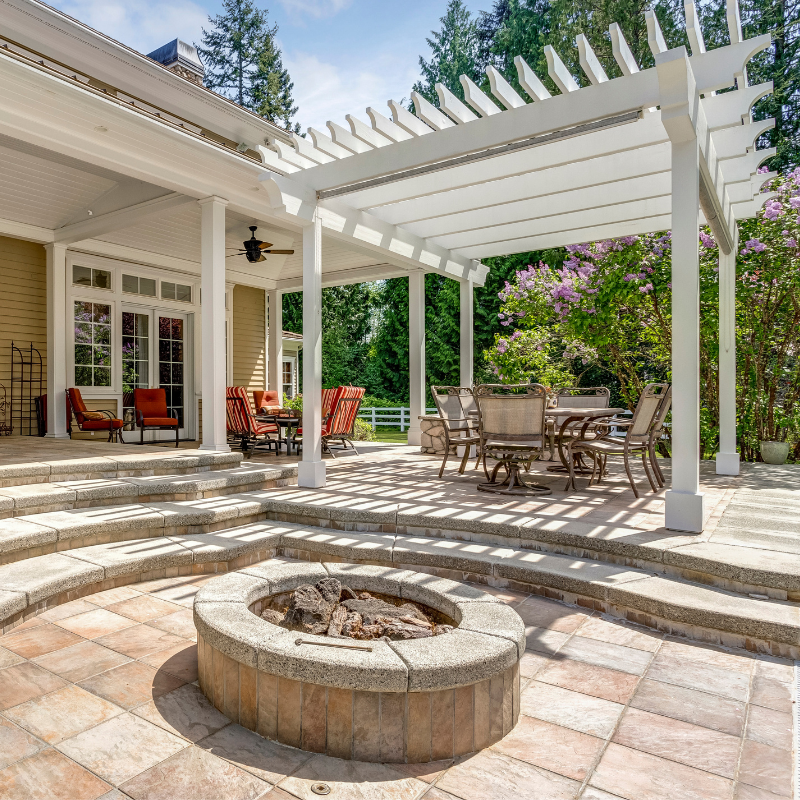 Two pink cyclamen flowers with dark purple bases against a blurred background.