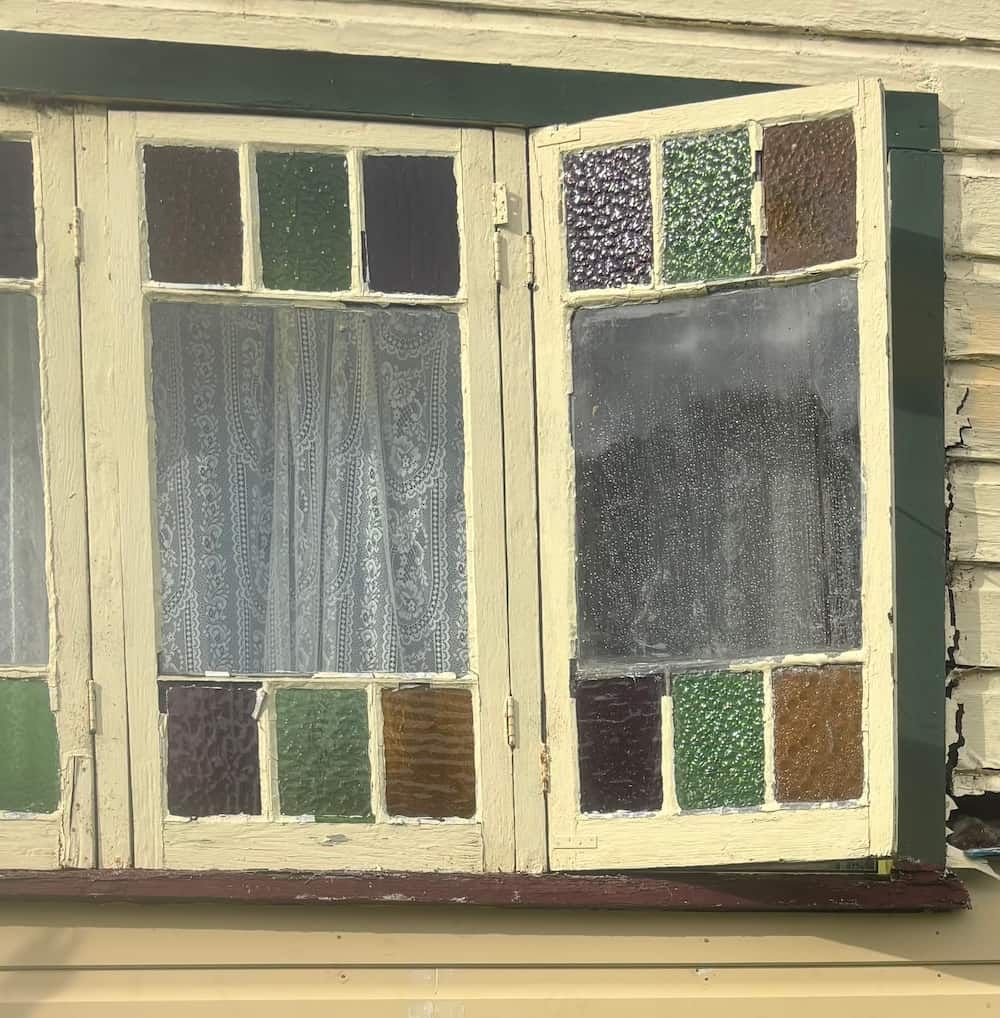A Window With Stained Glass On It Is Open — Gary Eslick Home Improvements In Berkeley Vale, NSW