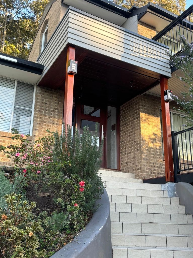 Exterior view of white brick stairs leading up to a house entryway — Gary Eslick Home Improvements In Berkeley Vale, NSW