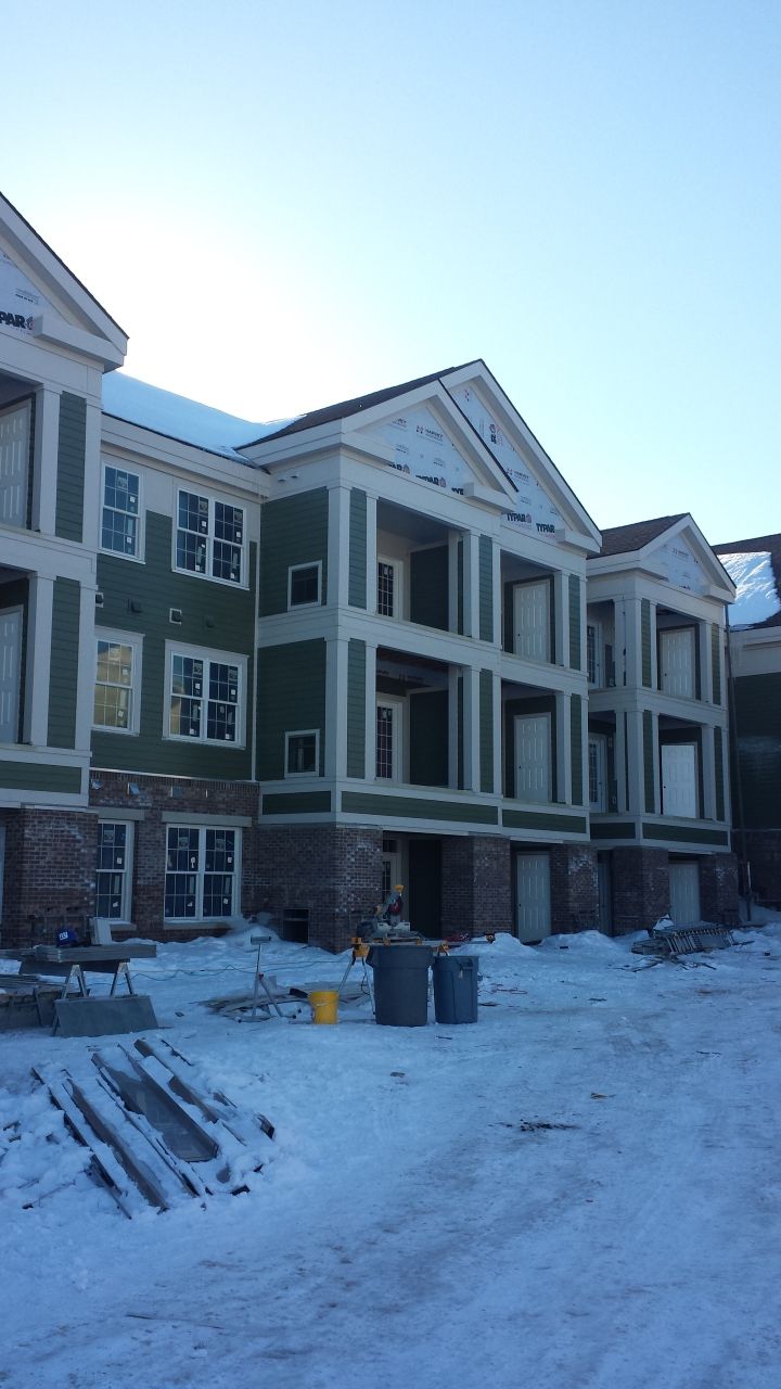 A large apartment building under construction in the snow