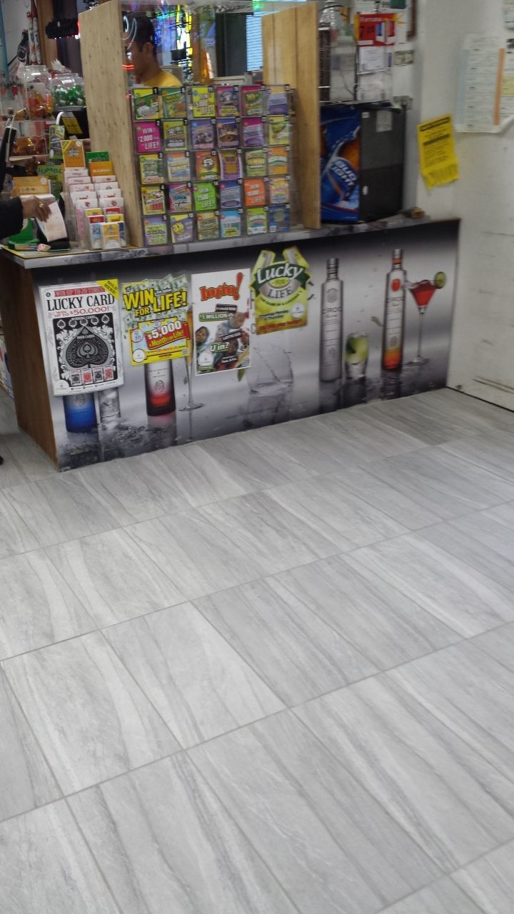 A counter in a store with a lot of drinks on it