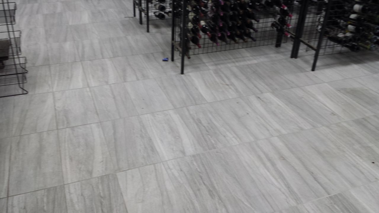 A black and white photo of a tiled floor in a store.