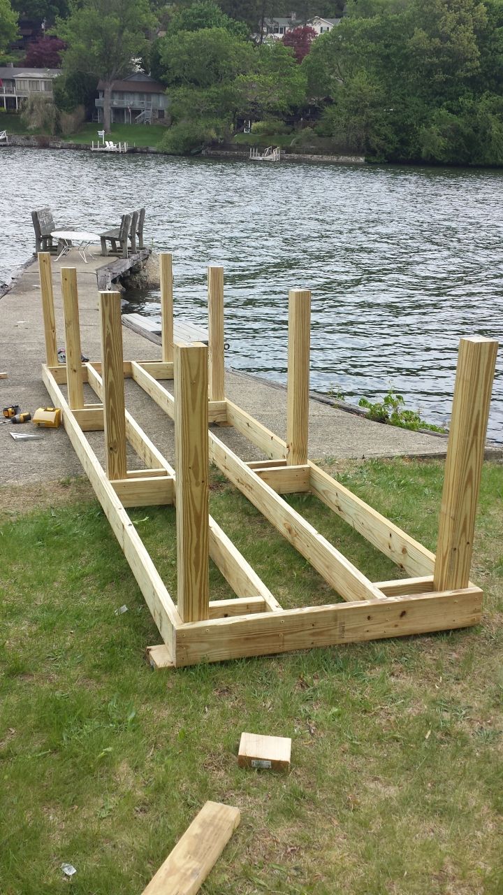 A wooden table is being built next to a lake.
