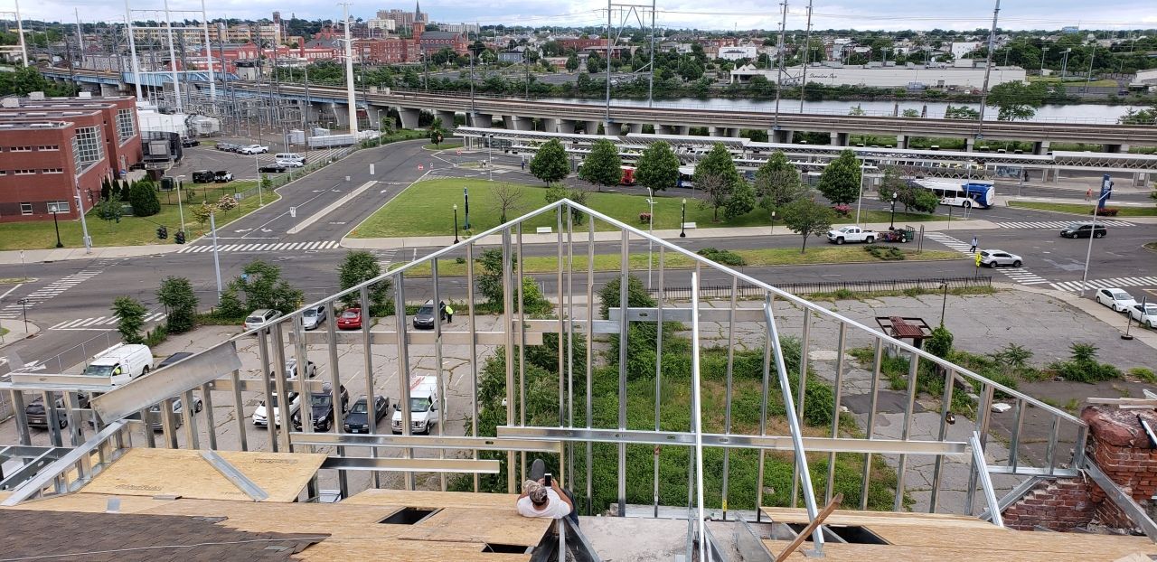 An aerial view of a building under construction in a city.
