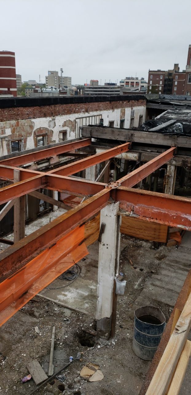 A large building with a lot of windows is being demolished.