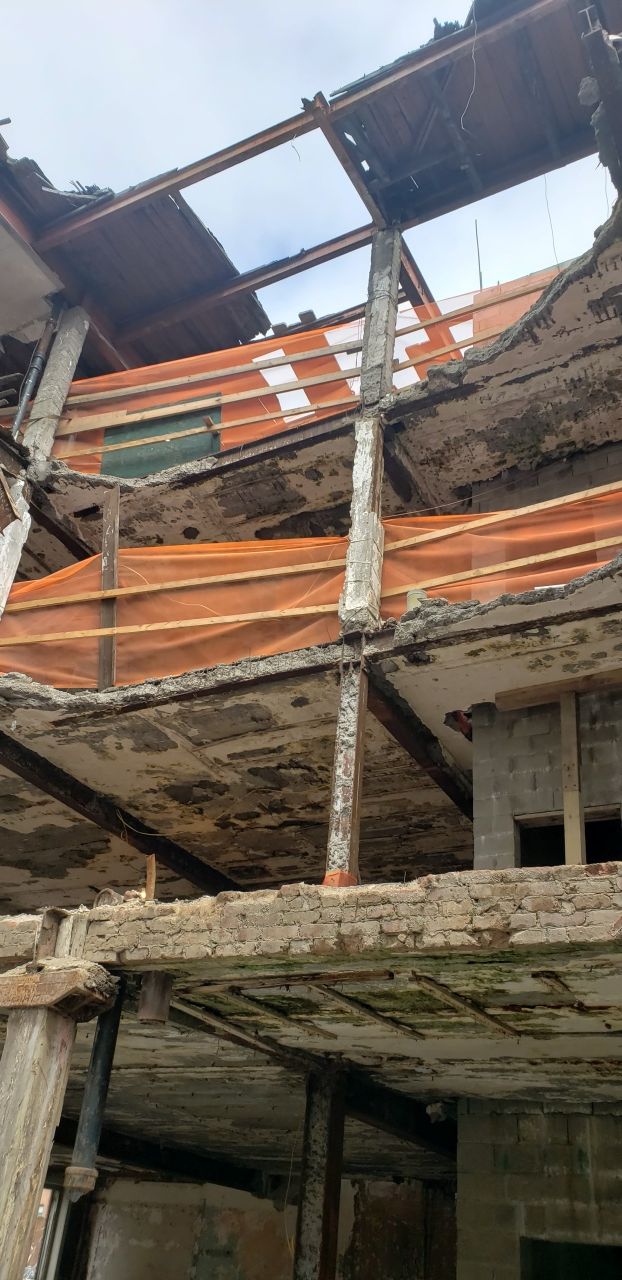 A building under construction with a roof that is missing.