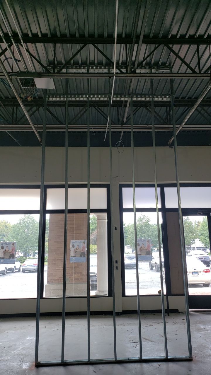 A room with a lot of windows and a ceiling that is being built.