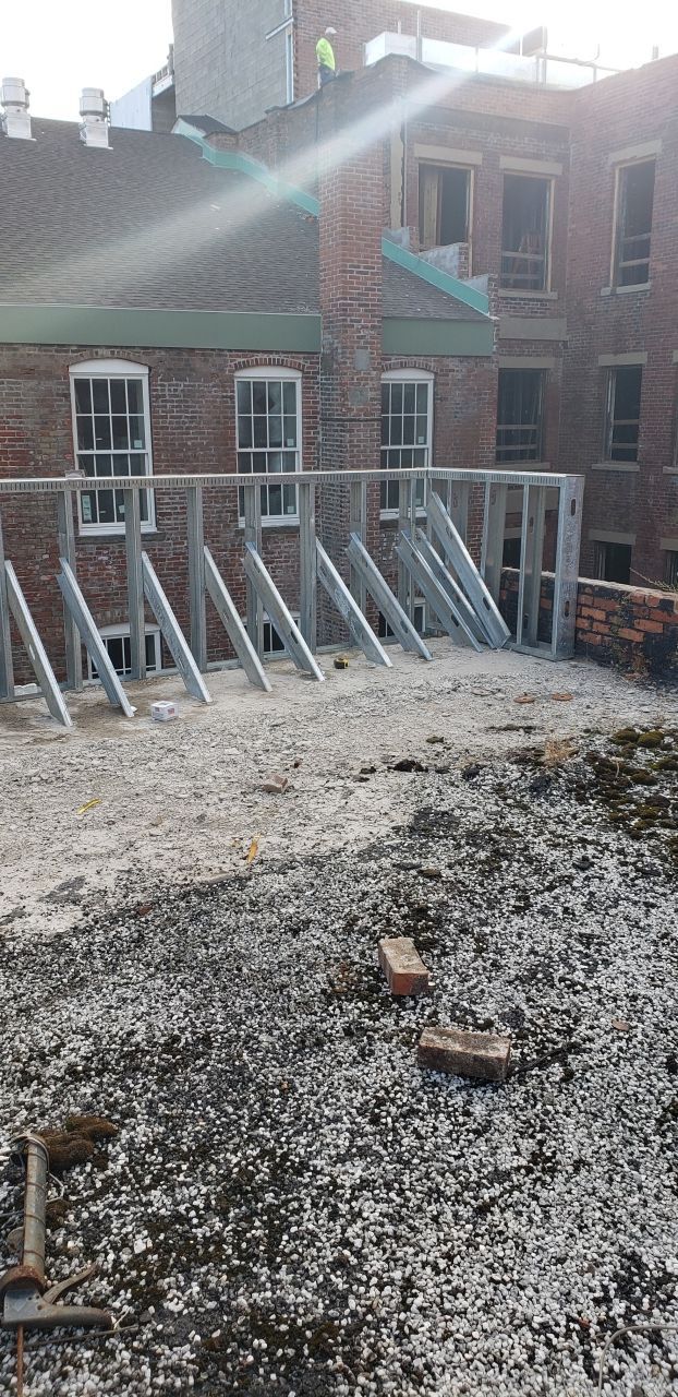 A construction site with a brick building in the background