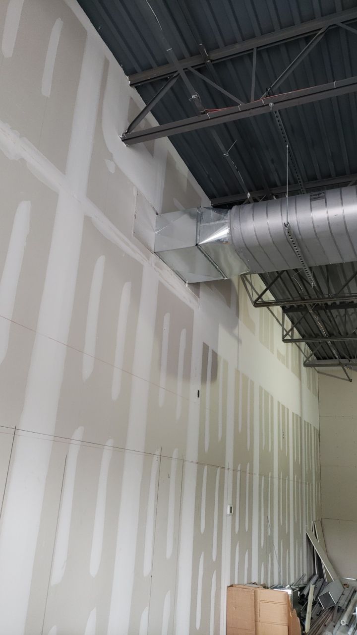 A room with a ceiling and a few boxes on the floor.