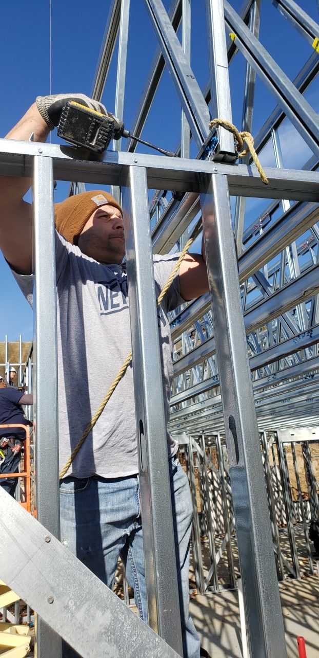 A man is standing on top of a metal structure.