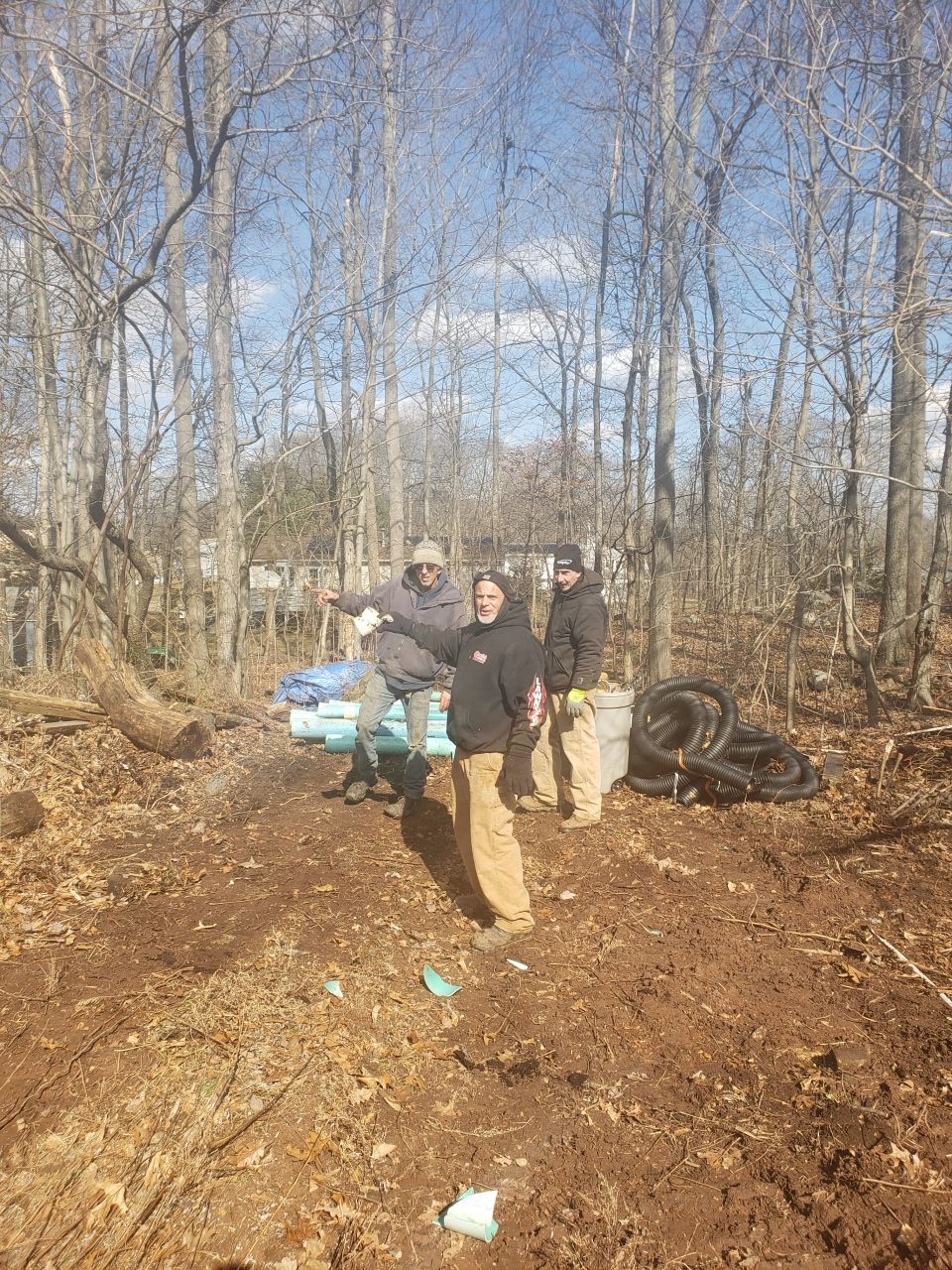 A group of people are standing in the middle of a forest.