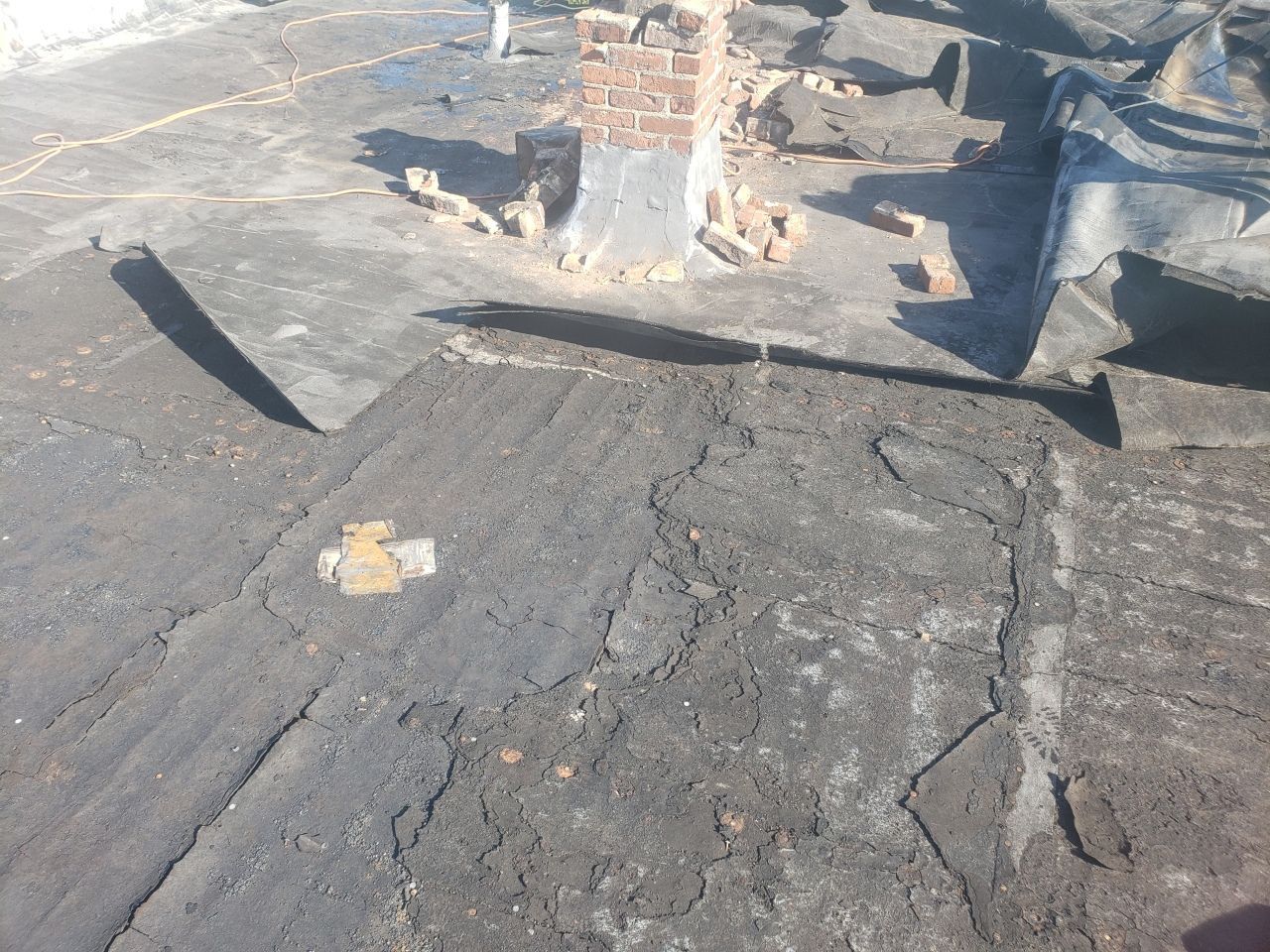 A person is standing on a concrete surface with a shadow on it.