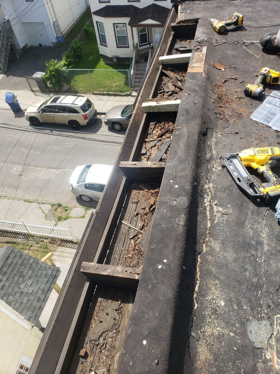 A gutter is being repaired on the roof of a building