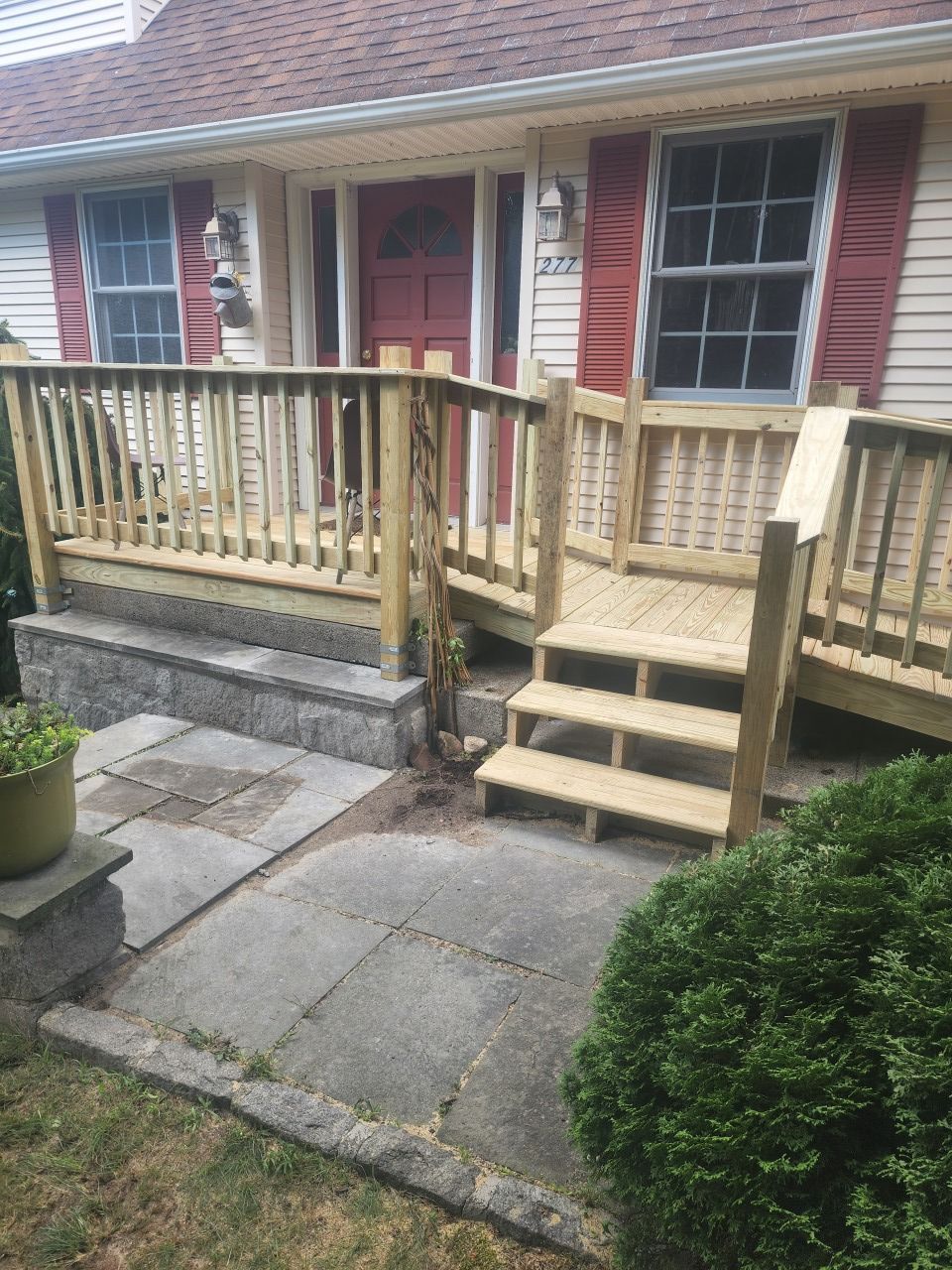 A house with a wooden deck and stairs