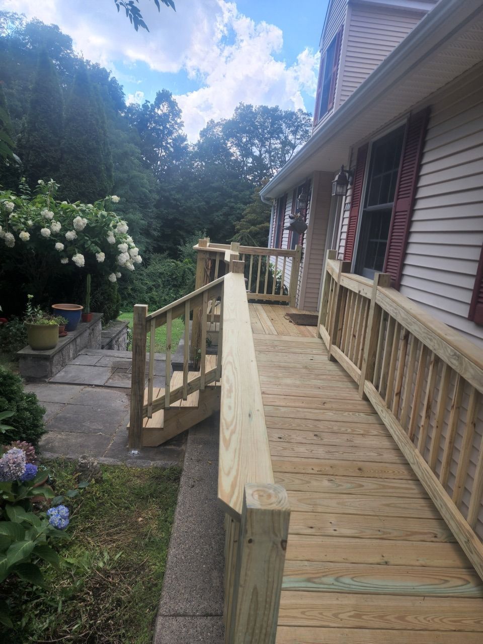 A wooden deck with stairs leading up to it