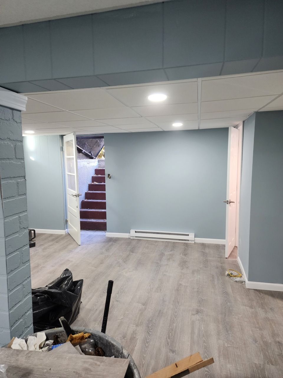 A basement with a staircase leading up to the second floor.