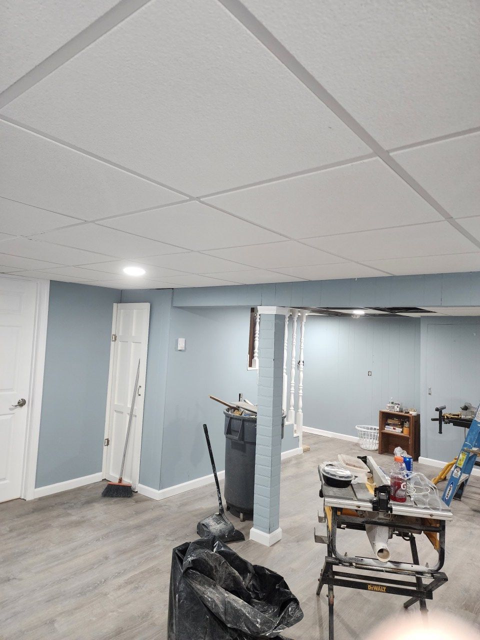 A basement with blue walls and a white ceiling.